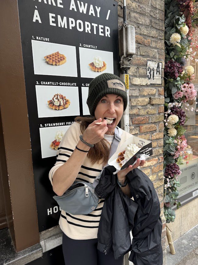 brugge person eating waffles with whipped cream