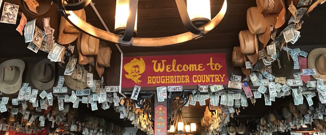 historic restaurant with dollar bills and cowboy hats hanging on the wall